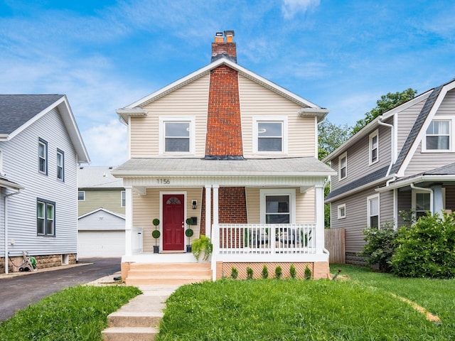 1156 S Champion Ave, Columbus, OH 43206 - view of front of property featuring a porch, a chimney, an outdoor structure, a garage, and a front lawn