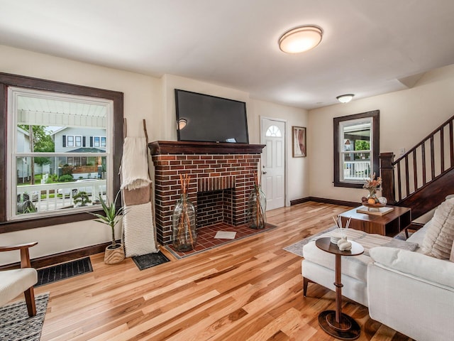 1156 S Champion Ave, Columbus, OH 43206 - living area featuring stairs, a fireplace, and wood finished floors