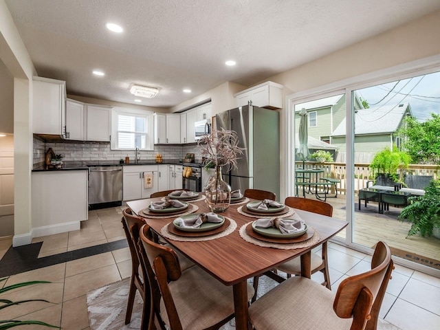 1156 S Champion Ave, Columbus, OH 43206 - dining space with light tile patterned flooring, a textured ceiling, and recessed lighting