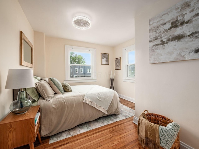 1156 S Champion Ave, Columbus, OH 43206 - bedroom featuring multiple windows and wood finished floors