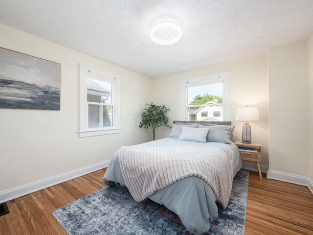 1156 S Champion Ave, Columbus, OH 43206 - bedroom with multiple windows and wood finished floors