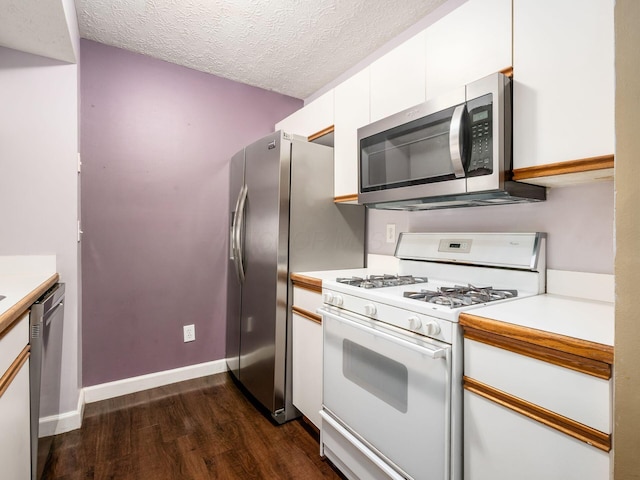 5678 Mango Ln Unit 104A, Hilliard, OH 43026 - kitchen featuring appliances with stainless steel finishes, dark wood-style flooring, white cabinets, a textured ceiling, and light countertops
