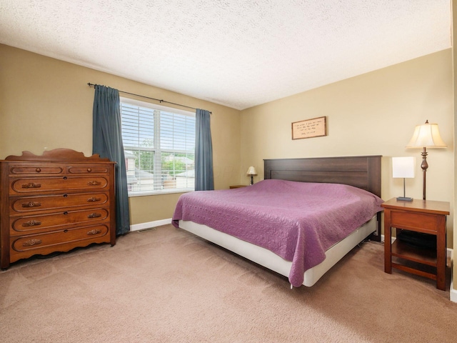 5678 Mango Ln Unit 104A, Hilliard, OH 43026 - bedroom with light carpet, a textured ceiling, and baseboards