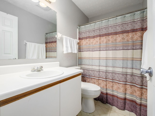 5678 Mango Ln Unit 104A, Hilliard, OH 43026 - bathroom featuring toilet, vanity, a textured ceiling, and tile patterned flooring