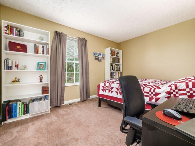 5678 Mango Ln Unit 104A, Hilliard, OH 43026 - bedroom featuring light carpet, a textured ceiling, baseboards, and a desk