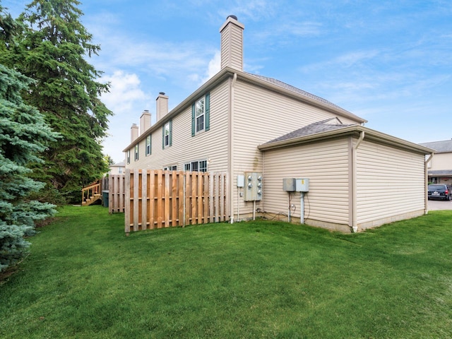 5678 Mango Ln Unit 104A, Hilliard, OH 43026 - back of house featuring a chimney and a yard