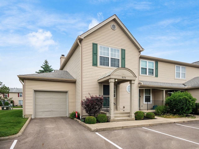 5678 Mango Ln Unit 104A, Hilliard, OH 43026 - view of front facade with a chimney, covered porch, and uncovered parking