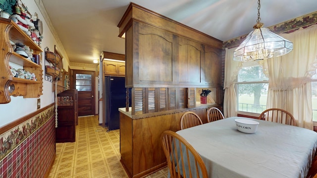 1371 Township Road 200, Bellefontaine, OH 43311 - kitchen with a chandelier, plenty of natural light, freestanding refrigerator, light floors, and ornamental molding