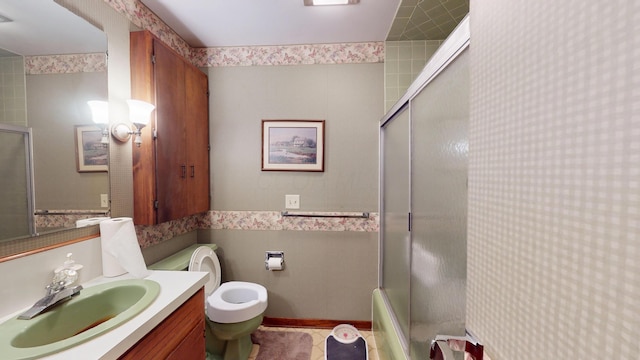 1371 Township Road 200, Bellefontaine, OH 43311 - bathroom featuring toilet, tile walls, vanity, combined bath / shower with glass door, and wallpapered walls