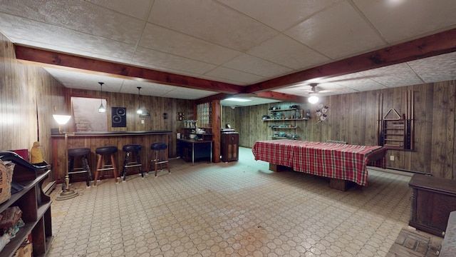 1371 Township Road 200, Bellefontaine, OH 43311 - living area featuring bar, wood walls, a ceiling fan, and a paneled ceiling
