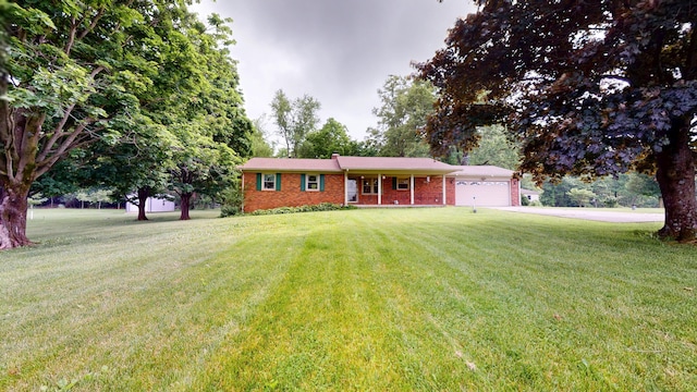 1371 Township Road 200, Bellefontaine, OH 43311 - ranch-style house with brick siding, a garage, a front lawn, and concrete driveway