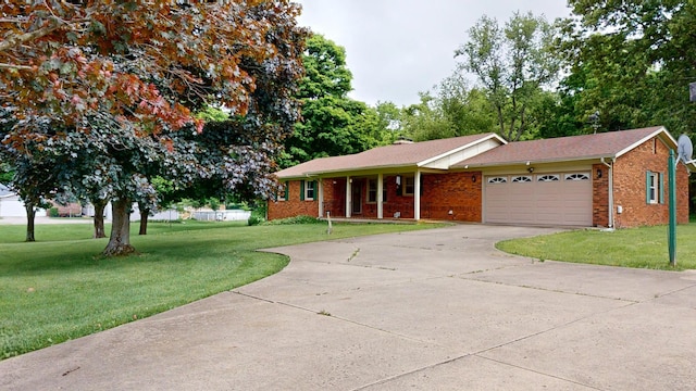 1371 Township Road 200, Bellefontaine, OH 43311 - ranch-style home with a front yard, a garage, driveway, and brick siding