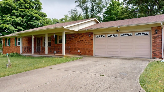 1371 Township Road 200, Bellefontaine, OH 43311 - single story home with brick siding, covered porch, a garage, driveway, and a front lawn