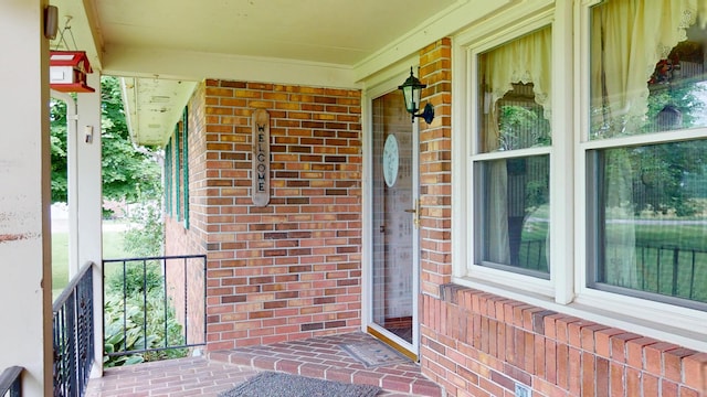 1371 Township Road 200, Bellefontaine, OH 43311 - property entrance featuring covered porch and brick siding