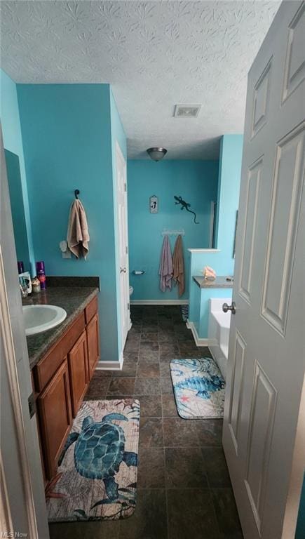 7360 Jones Rd, Nashport, OH 43830 - bathroom with a garden tub, vanity, baseboards, and toilet