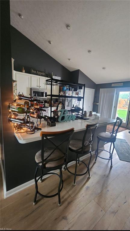 7360 Jones Rd, Nashport, OH 43830 - dining area with vaulted ceiling, light wood-style floors, and recessed lighting