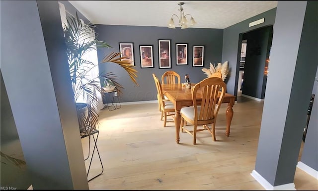 7360 Jones Rd, Nashport, OH 43830 - dining space featuring a chandelier, baseboards, and wood finished floors