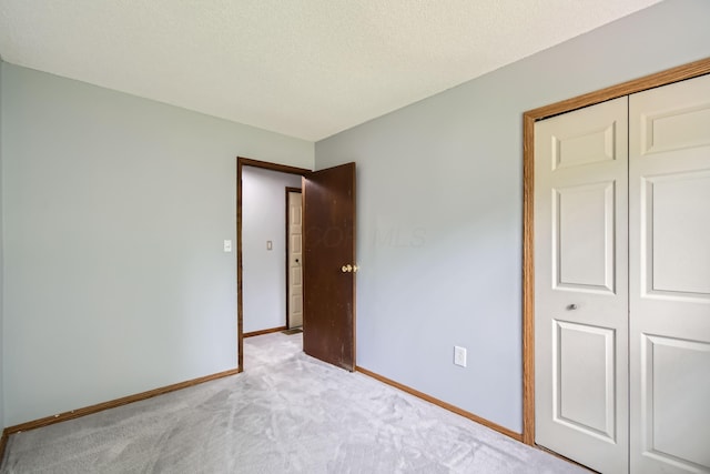 5827 Chanwick Dr, Galloway, OH 43119 - unfurnished bedroom with carpet flooring, baseboards, a closet, and a textured ceiling