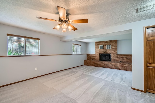 5827 Chanwick Dr, Galloway, OH 43119 - unfurnished living room with carpet, a ceiling fan, a textured ceiling, baseboards, and brick wall