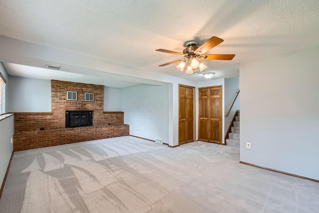 5827 Chanwick Dr, Galloway, OH 43119 - unfurnished living room with ceiling fan, stairs, carpet flooring, baseboards, and a textured ceiling