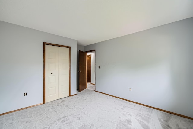 5827 Chanwick Dr, Galloway, OH 43119 - unfurnished bedroom with light colored carpet, a closet, and baseboards