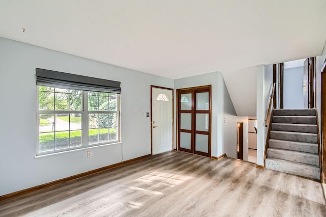 5827 Chanwick Dr, Galloway, OH 43119 - unfurnished living room with wood finished floors, baseboards, and stairway
