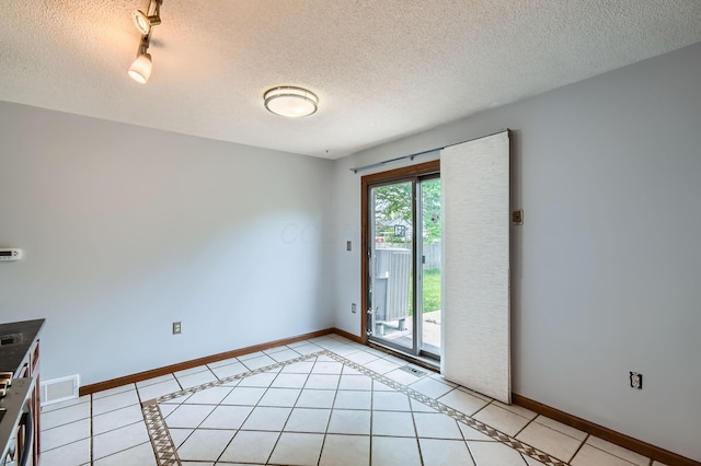 5827 Chanwick Dr, Galloway, OH 43119 - empty room with baseboards, a textured ceiling, and light tile patterned floors