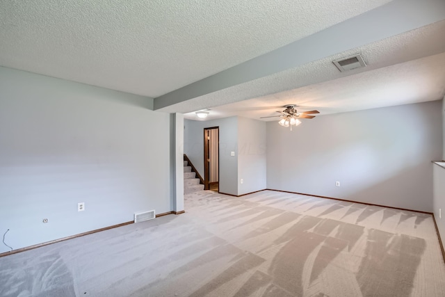 5827 Chanwick Dr, Galloway, OH 43119 - empty room featuring light carpet, stairway, ceiling fan, baseboards, and a textured ceiling