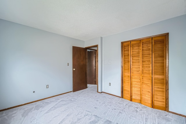 5827 Chanwick Dr, Galloway, OH 43119 - unfurnished bedroom with baseboards, light carpet, a closet, and a textured ceiling