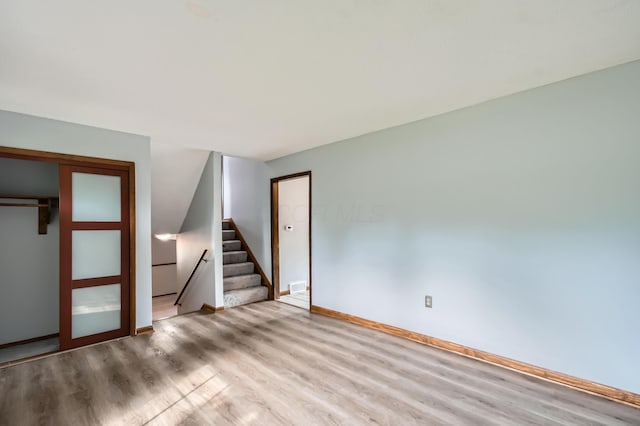 5827 Chanwick Dr, Galloway, OH 43119 - empty room with wood finished floors, stairway, and baseboards