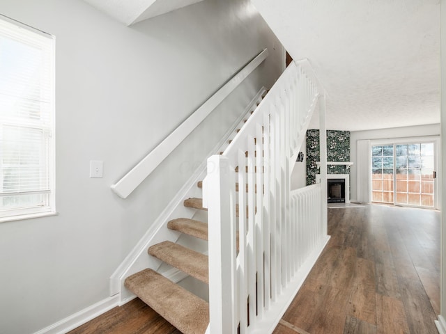 233 Malloy Ln Unit 78A, Blacklick, OH 43004 - staircase featuring wood finished floors and a large fireplace