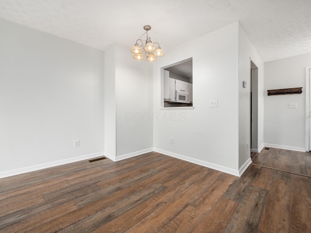 233 Malloy Ln Unit 78A, Blacklick, OH 43004 - unfurnished room featuring a chandelier, dark wood-type flooring, and baseboards