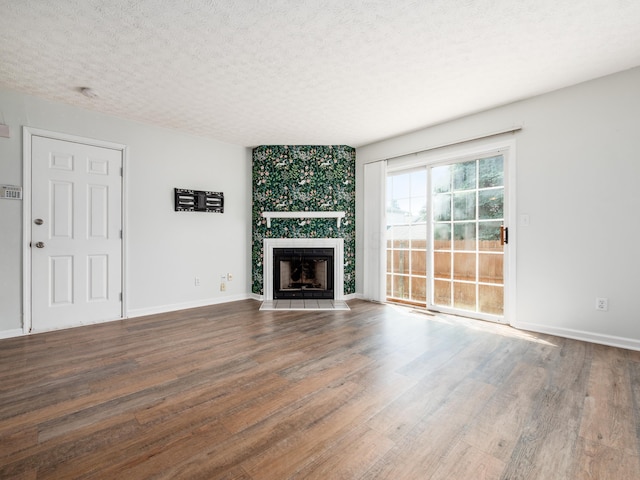 233 Malloy Ln Unit 78A, Blacklick, OH 43004 - unfurnished living room featuring wood finished floors, a fireplace, a textured ceiling, and baseboards