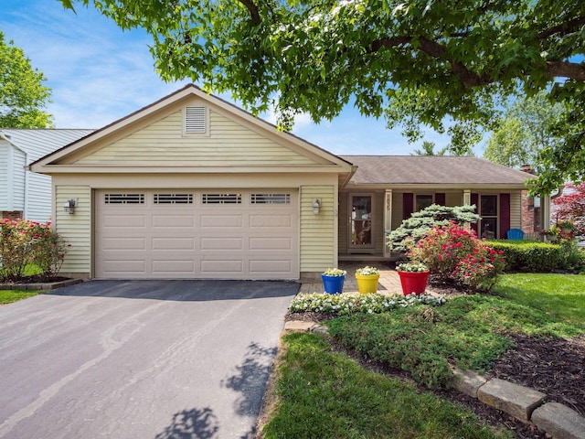 1835 Plains Blvd, Powell, OH 43065 - ranch-style house featuring asphalt driveway and a garage