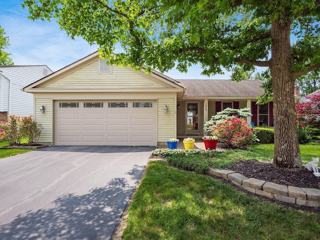 1835 Plains Blvd, Powell, OH 43065 - ranch-style home featuring asphalt driveway and a garage
