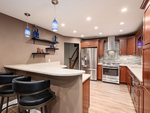 1835 Plains Blvd, Powell, OH 43065 - kitchen featuring stainless steel appliances, wall chimney exhaust hood, a peninsula, tasteful backsplash, and a breakfast bar area