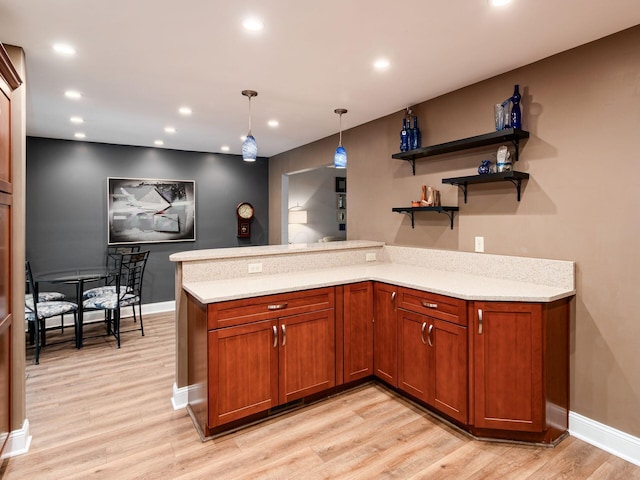 1835 Plains Blvd, Powell, OH 43065 - kitchen with light wood-style flooring, a peninsula, brown cabinets, recessed lighting, and hanging light fixtures