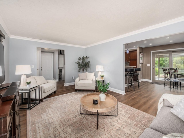 1835 Plains Blvd, Powell, OH 43065 - living area featuring wood finished floors, ornamental molding, a textured ceiling, and recessed lighting