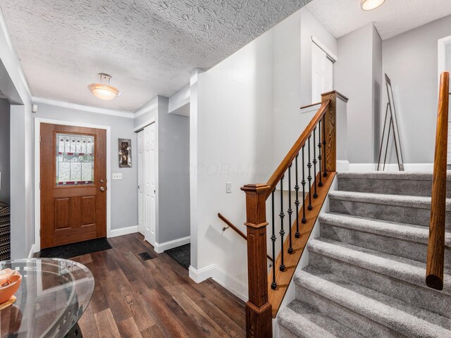 1835 Plains Blvd, Powell, OH 43065 - foyer featuring dark wood-style flooring, stairway, and a textured ceiling
