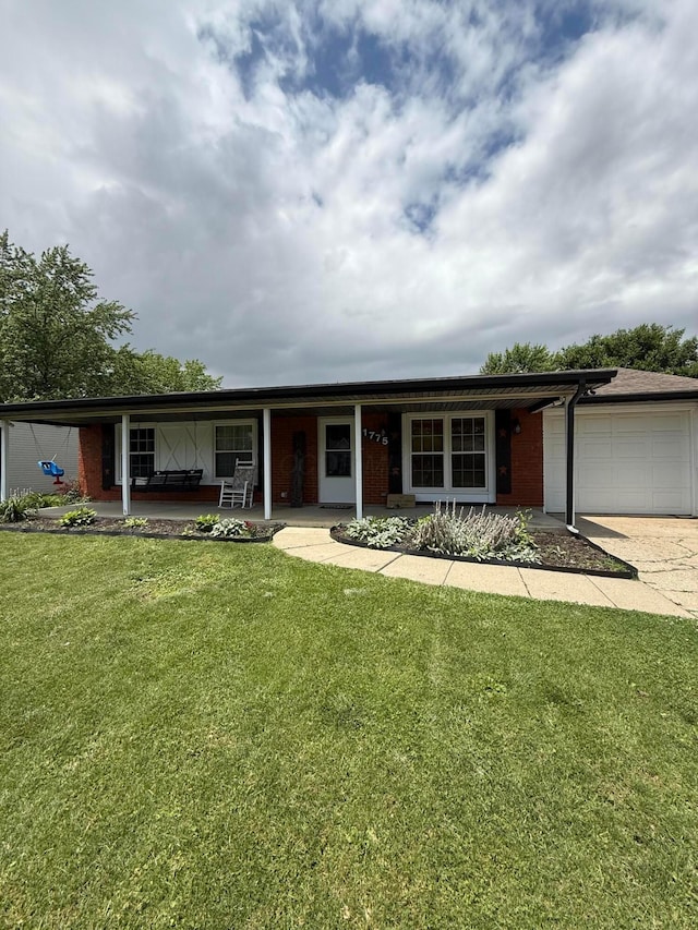 1775 Shoshoni Dr, Circleville, OH 43113 - ranch-style house featuring a porch, a garage, a front yard, driveway, and brick siding