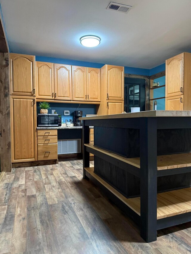 1775 Shoshoni Dr, Circleville, OH 43113 - kitchen with open shelves, stainless steel microwave, light brown cabinets, and wood finished floors