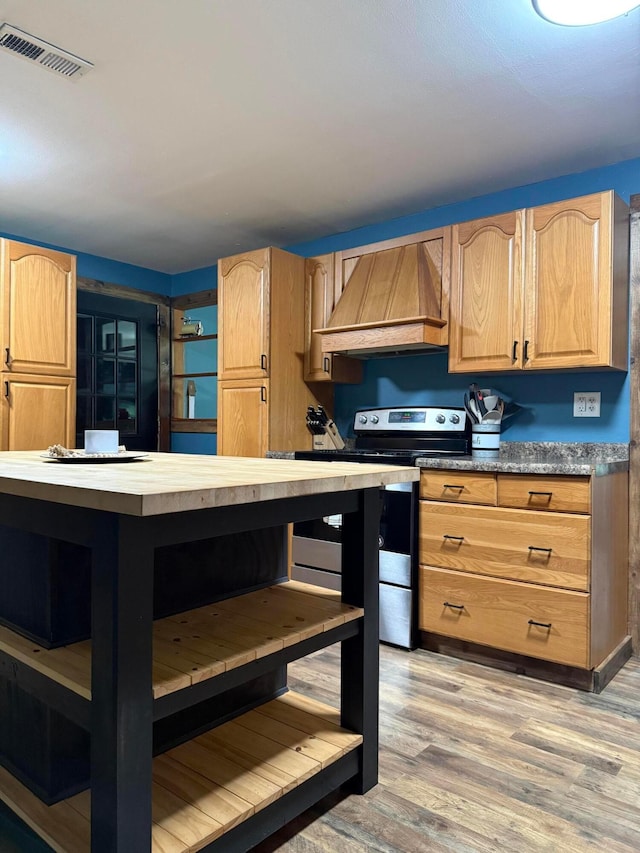 1775 Shoshoni Dr, Circleville, OH 43113 - kitchen with custom exhaust hood, open shelves, stainless steel electric range, light wood-type flooring, and light brown cabinetry