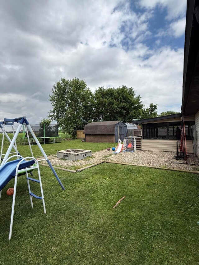1775 Shoshoni Dr, Circleville, OH 43113 - view of green lawn featuring a playground and a fire pit