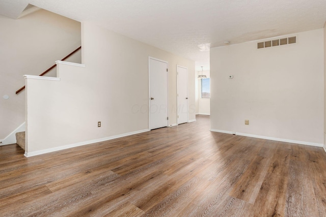 1955 Slaton Ct, Columbus, OH 43235 - empty room featuring stairs, wood finished floors, and baseboards