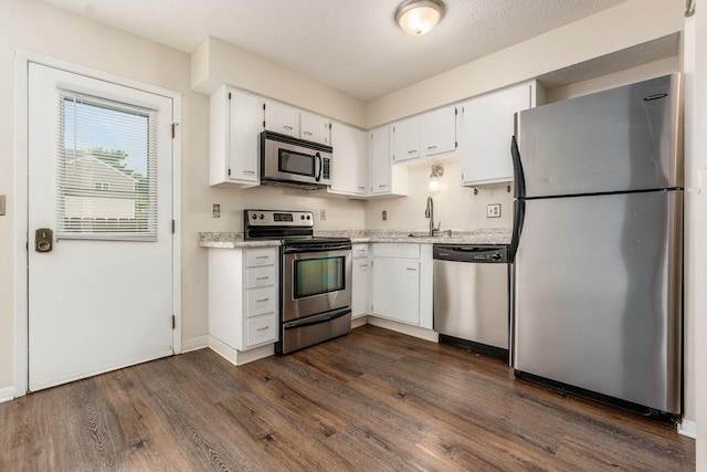 1955 Slaton Ct, Columbus, OH 43235 - kitchen with stainless steel appliances, dark wood finished floors, white cabinetry, and a sink
