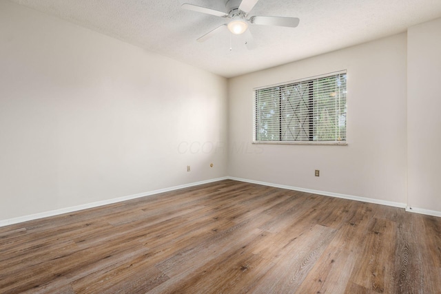 1955 Slaton Ct, Columbus, OH 43235 - unfurnished room featuring wood finished floors, baseboards, a ceiling fan, and a textured ceiling