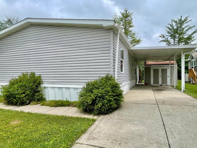 902 State Route 61 Lot # 92, Marengo, OH 43334 - view of side of home featuring concrete driveway and a carport