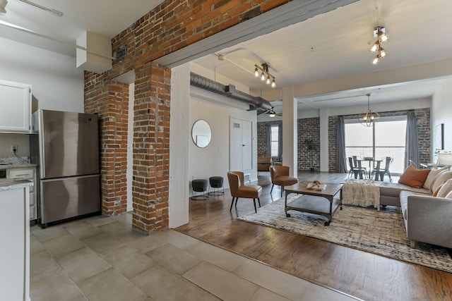 432 E Rich St Unit 4A, Columbus, OH 43215 - living area featuring light tile patterned floors, a ceiling fan, and brick wall