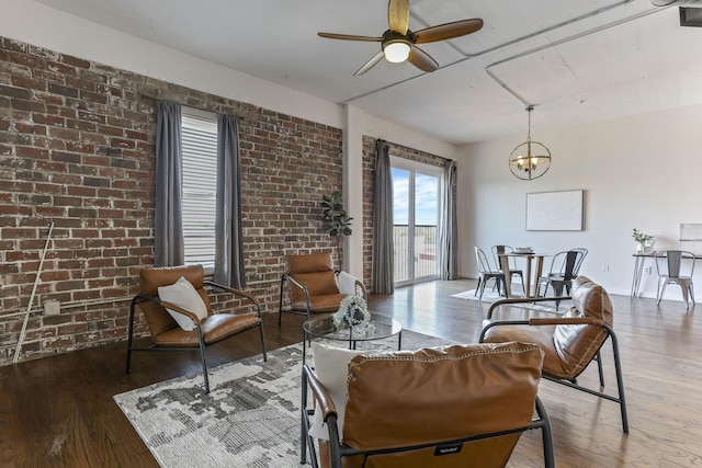 432 E Rich St Unit 4A, Columbus, OH 43215 - living area with wood finished floors, ceiling fan, brick wall, and a chandelier