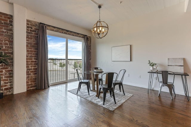 432 E Rich St Unit 4A, Columbus, OH 43215 - dining room with dark wood-style flooring, a chandelier, and brick wall